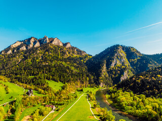 Peak Tri Koruny or Trzy Korony during day with green meadow and trees in spring. Pieniny National park in Slovakia and Poland . © Zedspider
