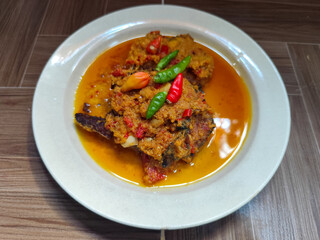 Tilapia with yellow curry, a traditional Indonesian dish, which has a delicious taste, beautifully presented.
