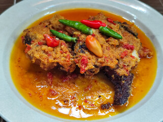Tilapia with yellow curry, a traditional Indonesian dish, which has a delicious taste, beautifully presented.
