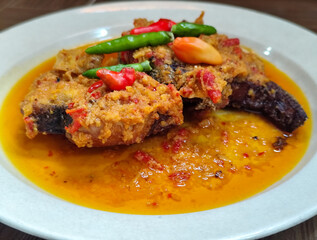 Tilapia with yellow curry, a traditional Indonesian dish, which has a delicious taste, beautifully presented.