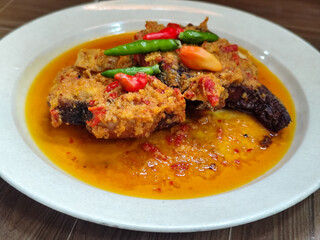Tilapia with yellow curry, a traditional Indonesian dish, which has a delicious taste, beautifully presented.