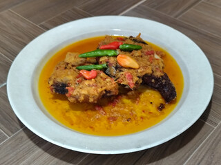 Tilapia with yellow curry, a traditional Indonesian dish, which has a delicious taste, beautifully presented.