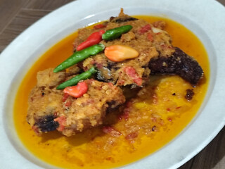 Tilapia with yellow curry, a traditional Indonesian dish, which has a delicious taste, beautifully presented.