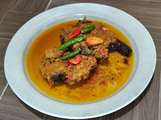 Tilapia with yellow curry, a traditional Indonesian dish, which has a delicious taste, beautifully presented.