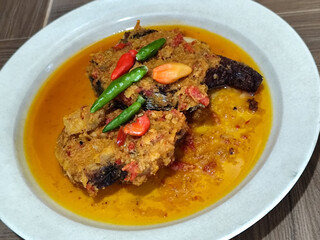 Tilapia with yellow curry, a traditional Indonesian dish, which has a delicious taste, beautifully presented.