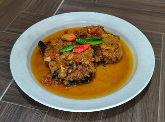 Tilapia with yellow curry, a traditional Indonesian dish, which has a delicious taste, beautifully presented.