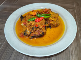 Tilapia with yellow curry, a traditional Indonesian dish, which has a delicious taste, beautifully presented.