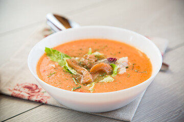Thick and creamy cream soup of trout in a plate