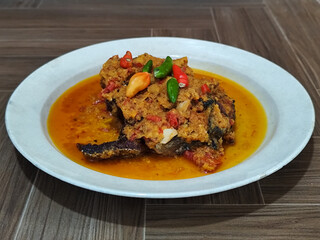 Tilapia with yellow curry, a traditional Indonesian dish, which has a delicious taste, beautifully presented.