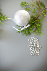 New Year's white ball and snowman on a background with a fir branch