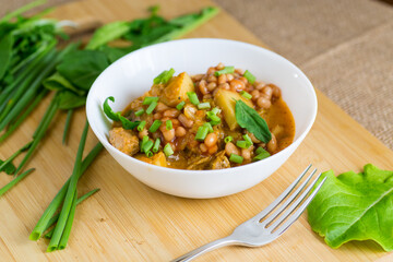 Traditional stewed stew with beans and meat in a country kitchen