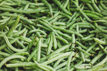A bunch of green beans are piled on top of each other