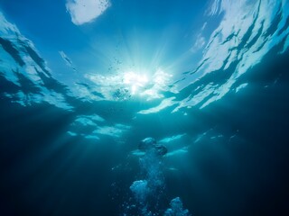 Underwater view of sunlight streaming through the ocean surface