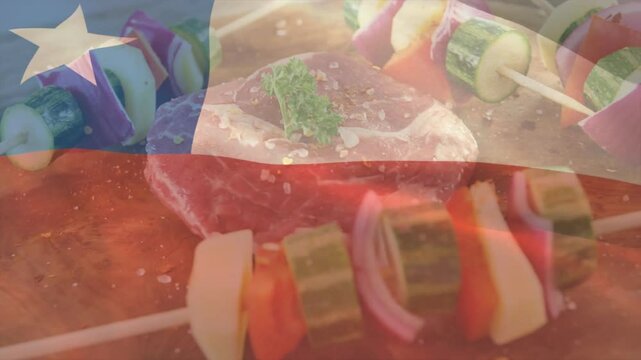 With Chilean flag appearing brush applying oil over raw beef steak for grilling and skewers shining