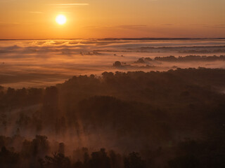 Aerial View of Sunrise and Morning Mist Over a Lowland Forest Landscape