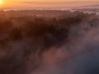 Aerial View of Sunrise and Morning Mist Over a Lowland Forest Landscape