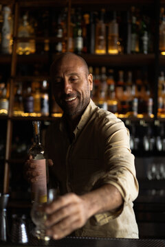 Mexican man talks about mezcal and tequila in a bar, master class