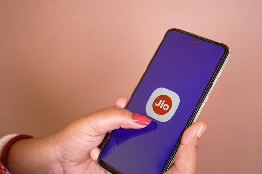 Jhargram, West Bengal, India - May 16, 2025: A woman holding a smartphone and My jio app icon on mobile screen. Mobile service provider on phone app.
