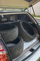 Car trunk loaded with four tires
