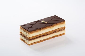 Elegant Chocolate Layered Cake Slice with Cream Filling and Gold Leaf