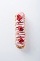 Top View of Raspberry Cream Eclair with Fresh Berries on White Background