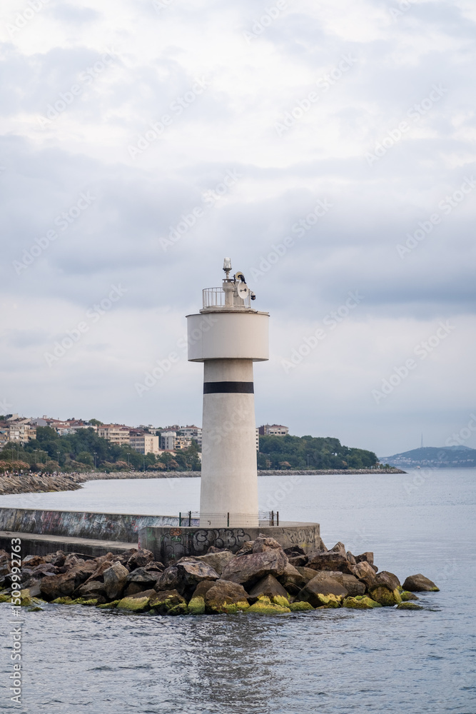 Aufkleber bosphorus lighthouse standing tall against the coastal skyline on a cloudy afternoon with calm water
