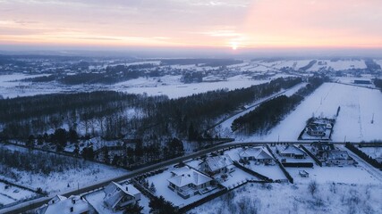 Snowfall in residential neighbourhood aerial view