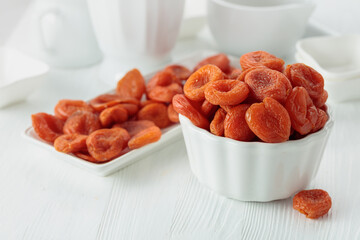 Organic dried apricots on a white table.