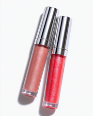 Closeup of two lip gloss tubes, one in soft pink shade and other in vibrant coral hue, showcasing their glossy finishes and sleek packaging. image evokes sense of beauty and elegance