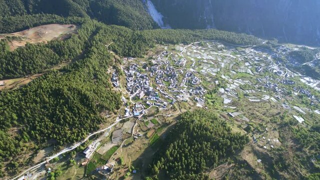 Drone view above Haba Village surrounded by greenery in the mountains of Yunnan Province, China