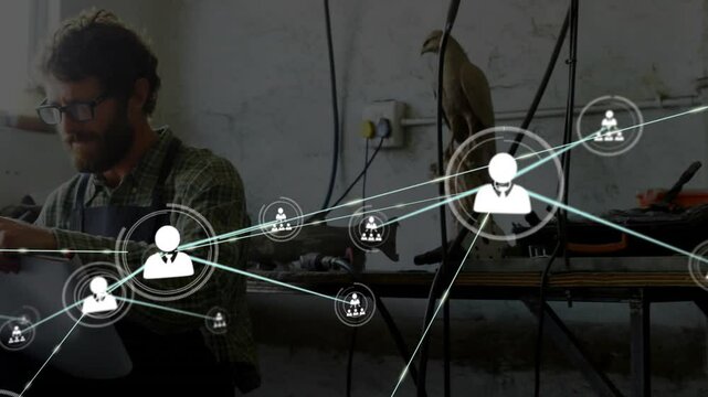 Craftsman typing on laptop beside bird sculpture initiating user icons forming digital network
