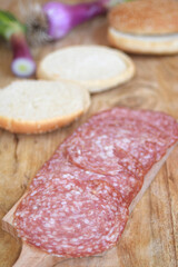 salami sandwich on wooden board
