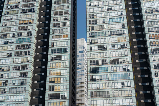 Detailed facade of high-rise buildings in Santa Fe, Mexico City, emphasizing repetitive geometric patterns, windows, and modern architecture design.