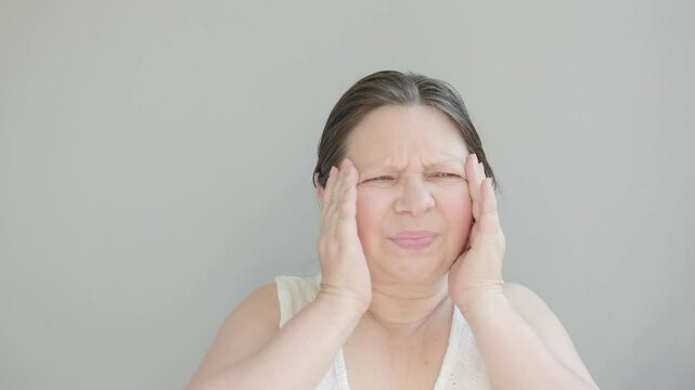 mature woman experiencing hot flashes due to menopause and high blood pressure, high blood pressure. Health concerns