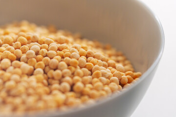 Close up of solid pea groats in round ceramic plate