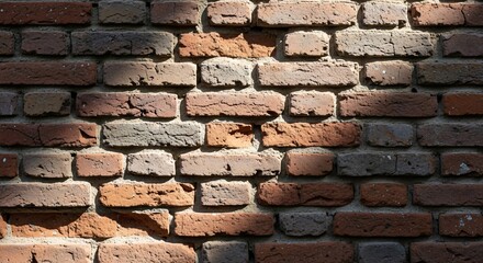 Fototapeta premium Detailed brick wall, showcasing an aged texture and unique arrangement