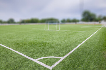 Football (soccer) field with new bright artificial surface. Corner marking. Training areas with small goals. Perfect solution that does not require maintenance in regions with water shortage.