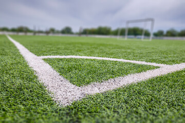 Football (soccer) field with new bright artificial surface. Corner marking. Training areas with...