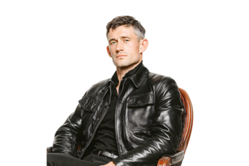 Man with short hair in black leather jacket sitting in wooden chair, isolated on a transparent background