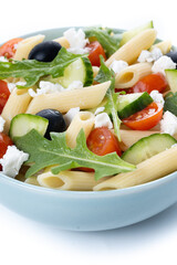 Mediterranean Pasta Salad in bowl with Fresh Vegetables and Herbs. Close up