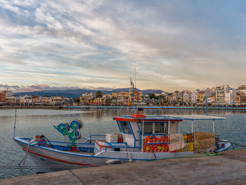 Dusk at Sitia Harbor with vibrant boats