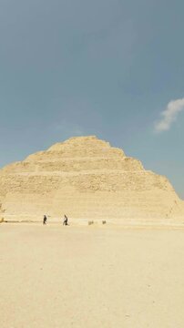 Tourists walking near the step pyramid of djoser in saqqara