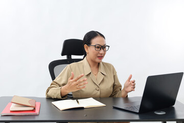 Female teacher in civil servant uniform with hand gestures during online meeting using a laptop