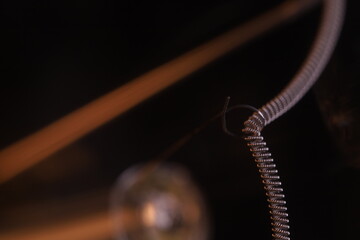 Tungsten filament, an incandescent light bulb, macro view, Metal texture in macro, silver wire