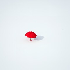 AI-Generated of Negative Space Concept with Minimalist Red Umbrella on White Background