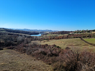 Scenic View Over Farka Lake Hills. A calm and scenic view over Farka Lake in Tirana, surrounded by olive trees, hills, and peaceful countryside atmosphere.
Farka Lake view Tirana Albania.