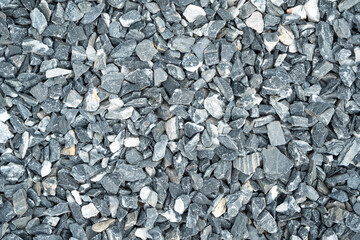 Close-up of natural crushed gravel stones in shades of gray and white. Ideal for construction,...
