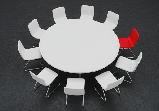 Overhead view of a round white table surrounded by white and red chairs