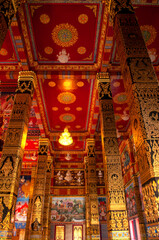 Fototapeta premium Ornate Interior of Chapel with Gold and Red Design at Wat Maha That Wachiramongkol (Wat Bang Thong), Phang Nga, Thailand – Traditional Thai Temple Art