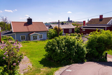 Picturesque colony of old small wooden historic houses on the Slottsberget mountain on the banks of the Gota alv river, Gothenburg, Sweden, sunny day